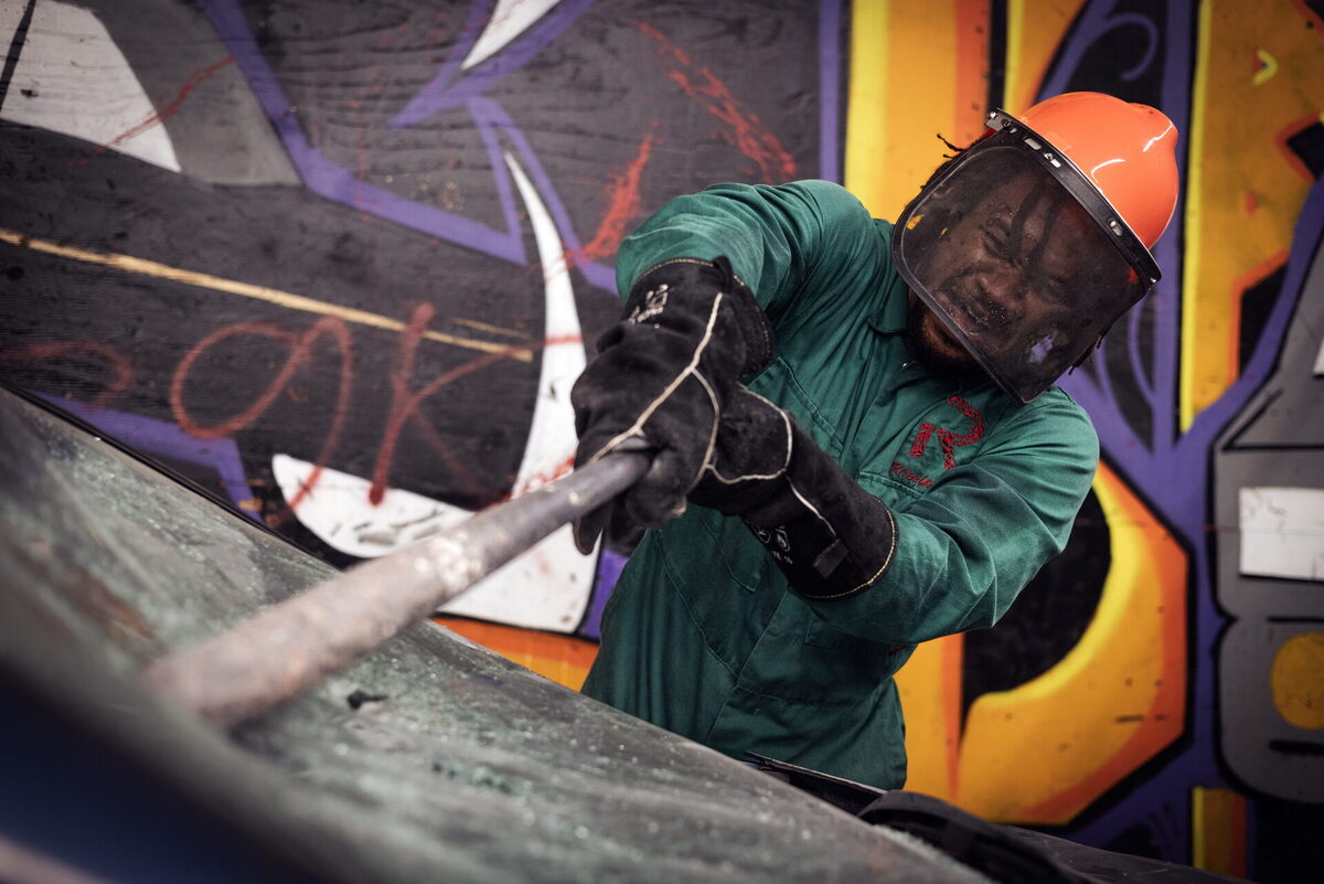 Rager smashing a car windshield with a bat at Rage Ground